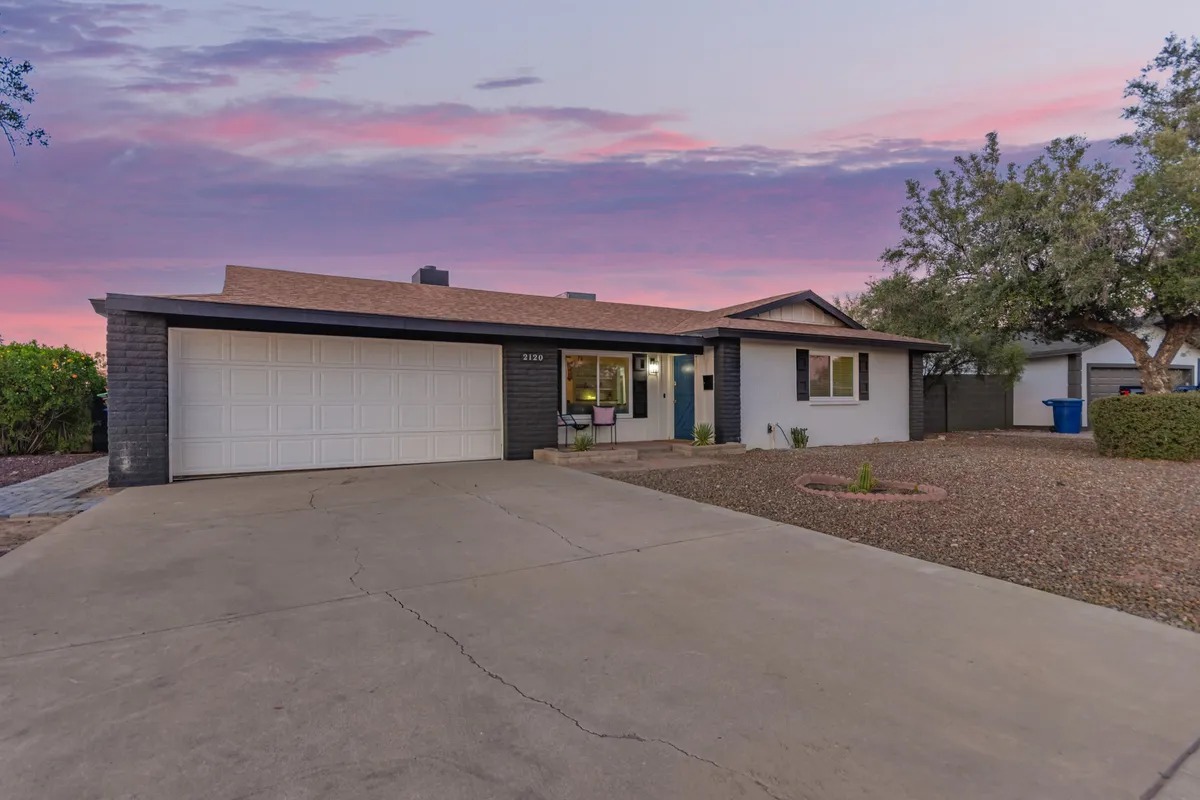 This image showcases the welcoming exterior of the house at sunset, emphasizing the inviting facade, garage door, front porch, and thoughtfully designed landscaping. The warm lighting hints at the perfect gathering spot for family and friends after an exciting day out.
